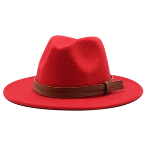 Detail of red wool fedora hat featuring a brown leather band with fine stitching