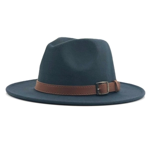 Detail of navy blue wool fedora hat featuring a brown leather band and silver buckle