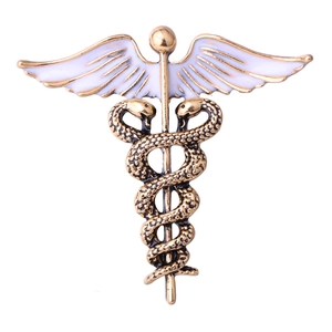Vintage gold Caduceus brooch with white enamel wings and snakes for suit lapels