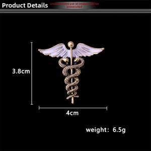 Macro detail of Caduceus brooch in vintage gold alloy with white enamel wings