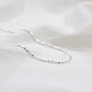 Minimalist S925 sterling silver cylinder pendant necklace on textured white fabric