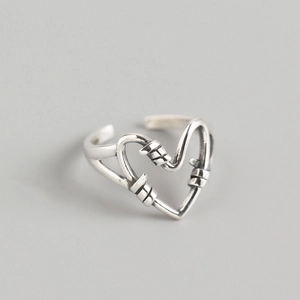 Detail view of vintage silver heart knot ring showing twisted texture and retro finish