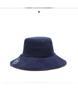 Close-up of navy blue wide brim sun hat with Happy Every Day white embroidery