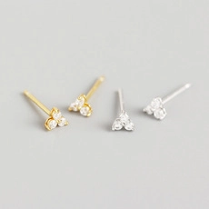 Macro shot of minimalist gold and silver S925 sterling silver geometric zircon stud earrings