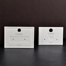Close-up of white jewelry display cards with Fashion text and heart-shaped hanging holes