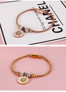 Detail of magnetic clasp and sparkling Tree of Life charms on metal square link bracelets