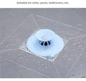 Blue silicone floor drain cover filtering hair on bathroom tiles, 100% waterproof usage