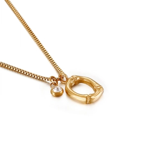 Golden stainless steel necklace featuring a bamboo-textured oval pendant with a round crystal