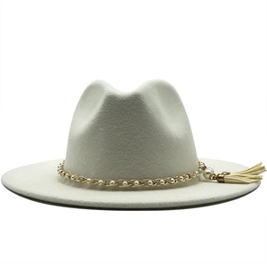 Detailed close-up of white wool fedora with gold pearl chain and elegant tassel
