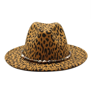 Detail of leopard print wool fedora featuring ethnic beaded band and wooden accents