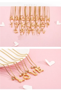 Detail of 26 gold alphabet necklaces with bamboo texture and cubic zirconia accents