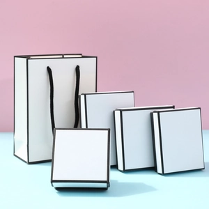 White minimalist jewelry gift box set with matching carrier bag and black border accents