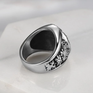 Vintage silver lion steel ring for men with embossed relief on white marble background