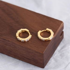 Macro shot of gold-plated S925 silver hoop earrings with rectangular cubic zirconia