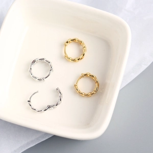 Close-up of gold and silver S925 sterling silver chain twist hoop earrings with easy-click clasp