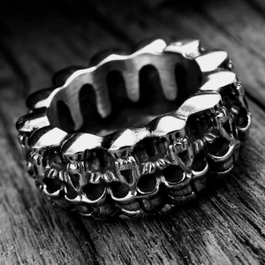 Retro stainless steel skull ring for men with vintage gothic relief on dark wood base
