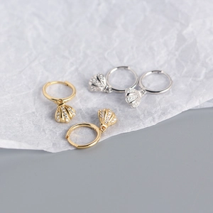 Detailed view of S925 sterling silver shell drop earrings in gold and silver finishes