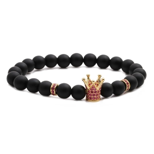 Detailed close-up of a matte black beaded bracelet with a pink zircon gold crown charm