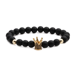 Matte black stone beaded bracelet with a gold crown charm centerpiece for women and men