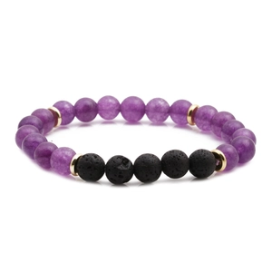 Amethyst and black volcanic lava stone beaded bracelet with golden spacers on white background