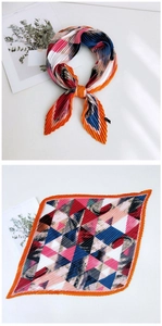 Detail of colorful geometric pleated scarf with orange and blue silk texture