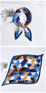 Detail of pleated square silk scarf with geometric color block design in blue and orange