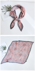 Close-up of pleated square scarf with grey borders and orange paisley pattern detail
