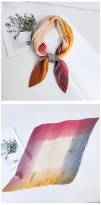 Detail of gradient pleated scarf showing fine texture and stylish bow knot styling