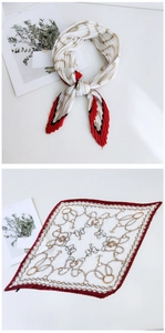 Detail of white pleated silk scarf with red edges and golden anchor chain print