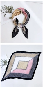 Detail of pleated silk scarf featuring geometric color blocks and elegant chain prints