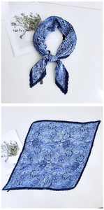 Detail of pleated silk scarf with blue paisley pattern and fine accordion fold texture