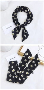 Detail of 100% cotton floral scarf with white daisy prints on a black background