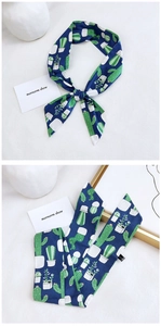 Detailed close-up of 100% cotton navy blue scarf with green cactus and succulent prints