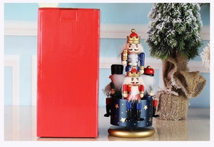 Close-up of European hand-painted nutcracker music box with festive red packaging box