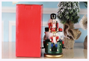 Nutcracker music box detail with festive red gift box and miniature wooden figurines