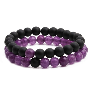 Set of matte black beads and purple amethyst stone bracelets on a white background