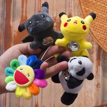 Close-up of four plush badges including cartoon characters and a colorful sun flower