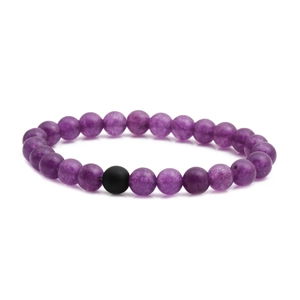 Macro detail of purple amethyst beads bracelet with a single matte black stone