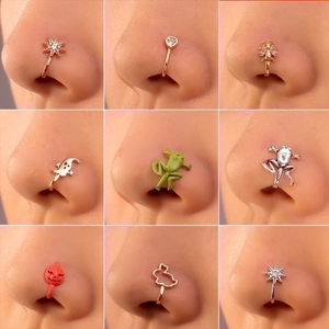 Close-up of nine assorted U-shaped non-piercing nose cuffs in gold and silver finishes