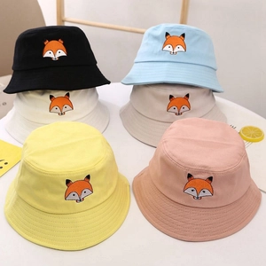Flat lay of six colored cotton sun hats with detailed fox embroidery for children