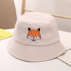 Detailed embroidery of a cartoon fox on a beige cotton bucket hat for children