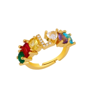 Detail of adjustable gold ring with multi-color gemstones and LOVE letter crystals