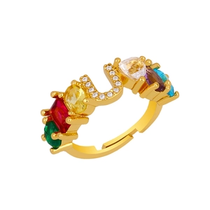 Detail of adjustable gold-plated ring with colorful zirconia stones and U-shaped accents