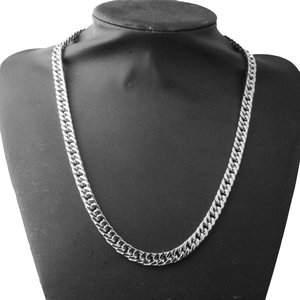 Detailed view of silver 8mm double-woven Cuban chain necklace on a black bust mannequin