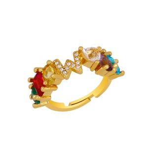 Detailed shot of adjustable gold ring with multi-colored crystals and W-shaped pavé accents