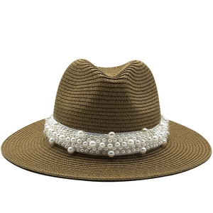 Brown straw Fedora sun hat with elegant white pearl trim for women on white background