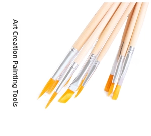 Macro detail of 12 paint brushes showing synthetic golden bristles and wooden handles