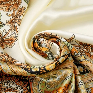 Satin silk scarf featuring vintage orange paisley patterns with smooth spiral draping