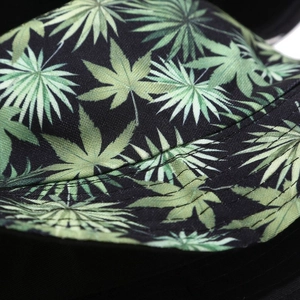 Close-up of durable cotton canvas bucket hat with green leaf print and double stitching