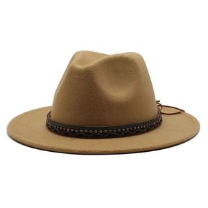 Detail of camel wool fedora with woven band and diamond accents on flat wide brim